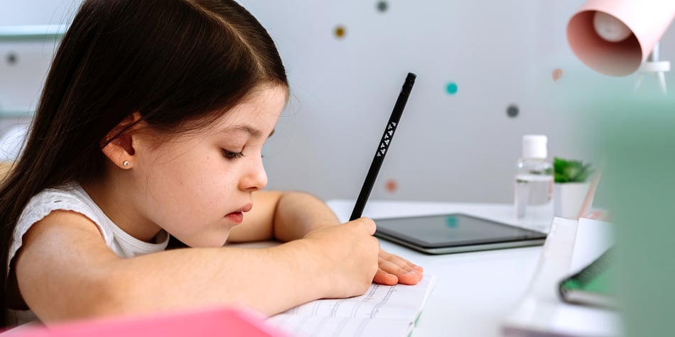 girl-doing-homework-sitting-at-a-desk-2022-01-05-19-09-02-utc